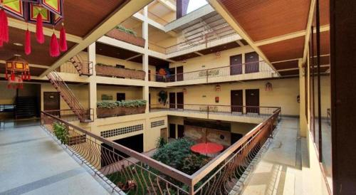 a large building with balconies and plants in it at King Hotel in Loei