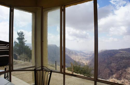 a room with a view of a mountain view at Dana Village lodge and Camp-Wadi Dana Eco camp in Dana