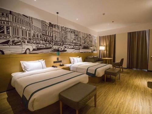 Ένα ή περισσότερα κρεβάτια σε δωμάτιο στο City Comfort Inn Laibin Wuxuan Yuda
