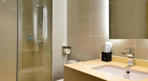 a bathroom with a shower and a sink and a shower at City Comfort Inn Xiaogan Hubei Engineering College in Xiaogan