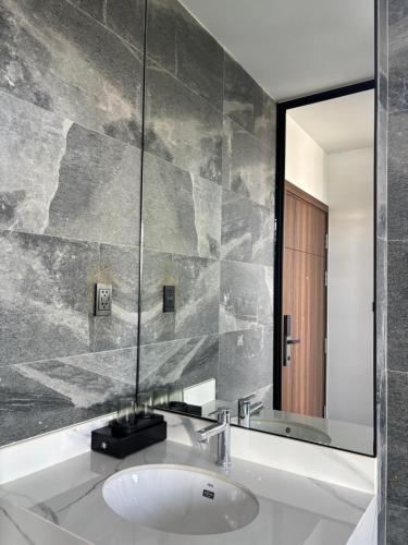 a bathroom with a sink and a mirror at MAIA Hotel & Apartment Danang in Da Nang