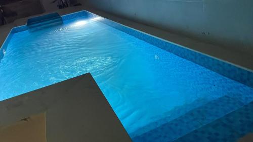 a large swimming pool with blue water at Roses House Ladies & families only in Luxor