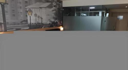 a kitchen with a counter top and a window at Thank Hotel Shandong Weifang North High-speed Railway Station in Weifang