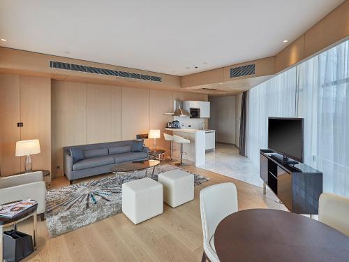 a living room with a couch and a table at Wyndham Grand Istanbul Levent Hotel & Conference Center in Istanbul