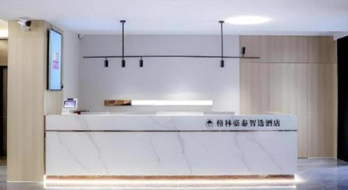 a kitchen with a white counter in a room at GreenTree Inn Express Hefei City Bus Station in Feicheng