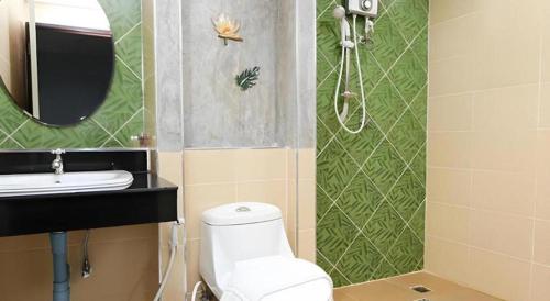 a bathroom with a toilet and a sink and a mirror at Soontree House Hotel in Udon Thani