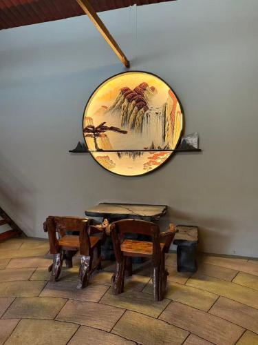 a mirror hanging on a wall with tables and chairs at MR B hotel in Bukit Mertajam