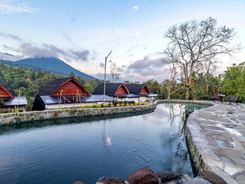 a pool of water in front of a resort at Shankara Forest Haven Villa by AGATA in Jatiluwih