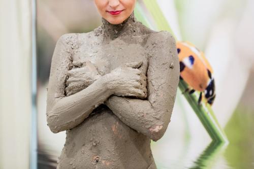 a woman standing in the mud with her arms crossed at Medical SPA "Eglės sanatorija" Birštonas in Birštonas