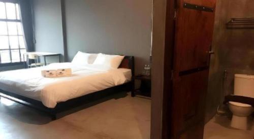 a bedroom with a bed with two towels on it at Rider bedroom hostel & cafe in Hua Hin