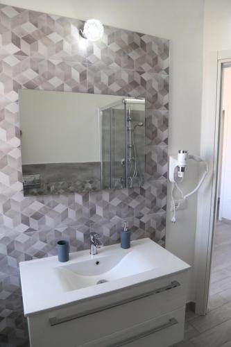 a bathroom with a sink and a mirror at B&B Mimì in Castelsardo