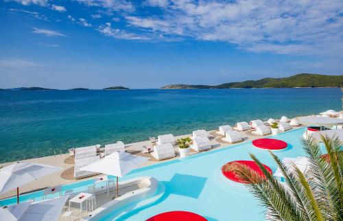 an aerial view of a resort with a swimming pool and the ocean at Amadria Park Beach Hotel Jure in Šibenik