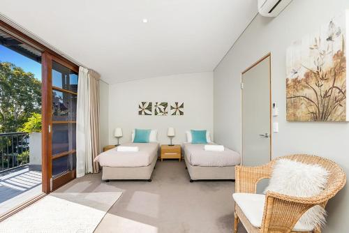a living room with a bed and a couch at Casablanca - 2 - 21-25 Fletcher Street in Byron Bay