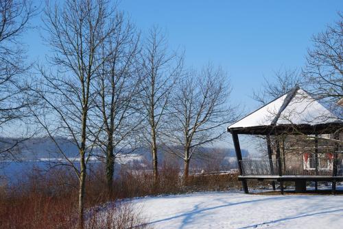 a gazebo with snow on it next to trees at Hotel De Oude Brouwerij in Mechelen