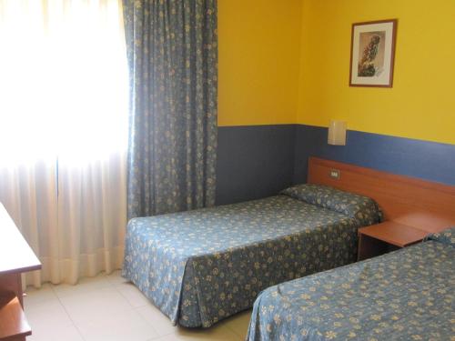Ένα ή περισσότερα κρεβάτια σε δωμάτιο στο Hotel Blauet by Bossh! Hotels