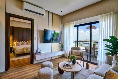 a living room with a television and a bedroom at ® {The~City~LUX~Place}@DowtownSD in La Julia