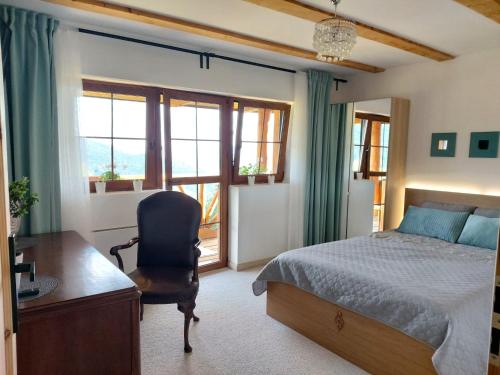 a bedroom with a bed and a desk and a chair at Żaroowka Slow House in Międzybrodzie Żywieckie
