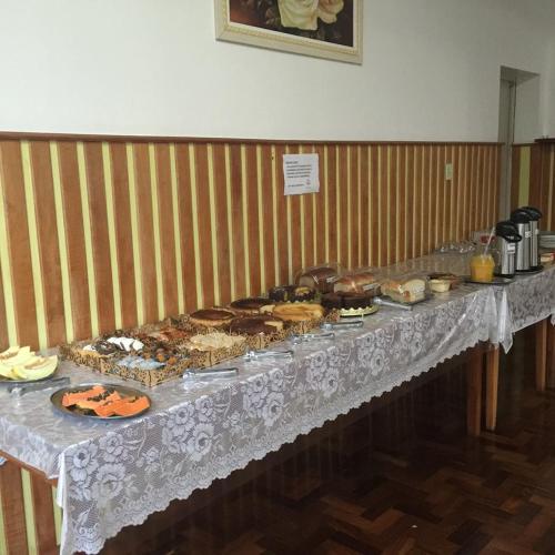 a table with many different types of food on it at Ouro Preto Hotel in Restinga Sêca