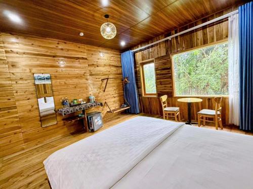 a bedroom with a bed and a wooden wall at Tuyet's Homestay in Ninh Binh
