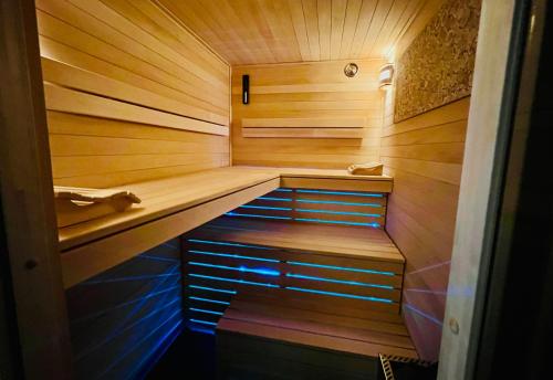 a small sauna with wooden walls and wooden floors at INTERGO Apartments in Brackel