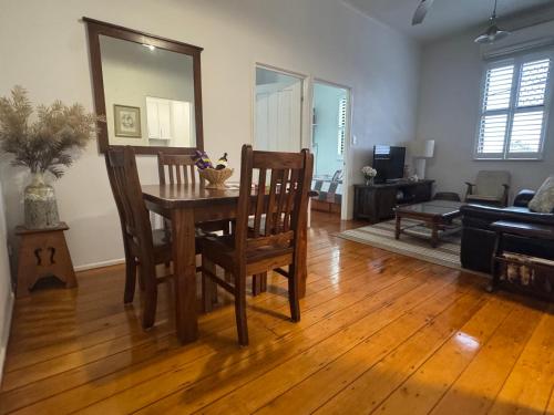 a living room with a wooden table and chairs at Urbane on William in Rockhampton