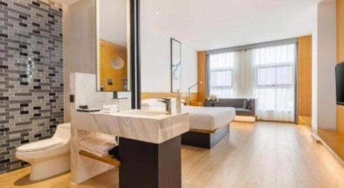 a bathroom with a sink and a toilet at Fairfield by Marriott Baoding High-Tech Zone in Baoding
