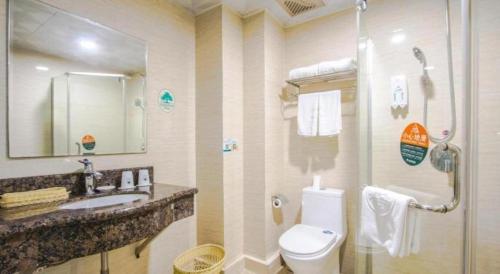 a bathroom with a toilet and a sink and a shower at GreenTree Inn Jiaxing Tongxiang Tudian Express Hotel in Jiaxing