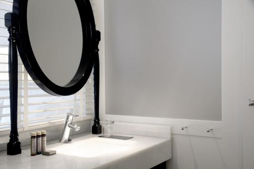 a bathroom with a mirror and a sink at Ofelias Hotel 4Sup by Bondia Hotel Group in Barcelona