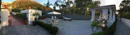 a rendering of a house with a hammock and a mountain at Casa Arcada in Vulcano
