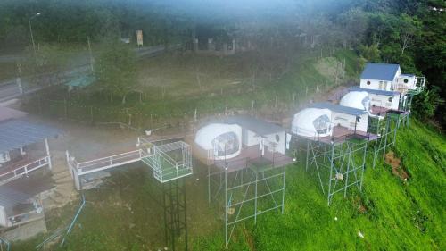 an aerial view of a group of domes in a field at เอวาเเคมป์ ภูชี้ฟ้า Avacamp phuchifa in Ban Seng Choi