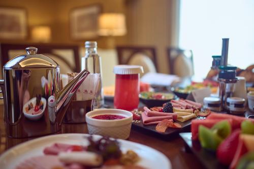 a wooden table with plates of food on it at Marriott Hotel Jabal Omar Makkah in Makkah