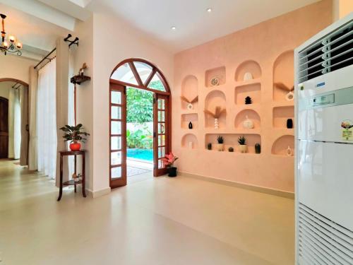 a living room with an arched doorway and an entry way at Villa Laz, Parra close to calangute- Pool,Jacuzzi,Cook in Parra