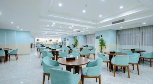 a waiting room with tables and chairs in a hospital at Guilin Manhatton Hotel Tianjie in Guilin