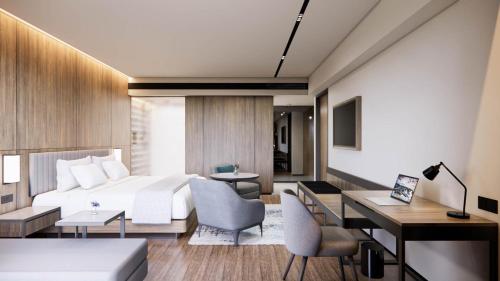 a hotel room with a bed and a desk at Oakwood Yogyakarta in Jetis