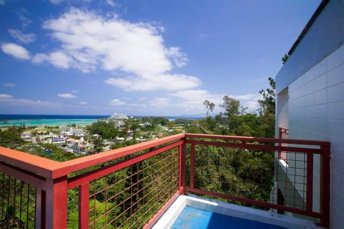 a balcony with a view of the ocean at Surfside Bed & Breakfast in Onna