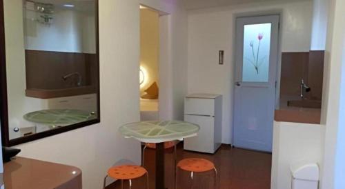 a bathroom with two stools and a sink and a mirror at House of Big Brother in Puerto Princesa City