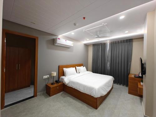 a bedroom with a bed and a television in it at Sagar Stays in Jaipur