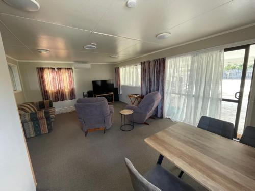 a living room with a wooden table and chairs at Quiet & Close to Town in Taupo