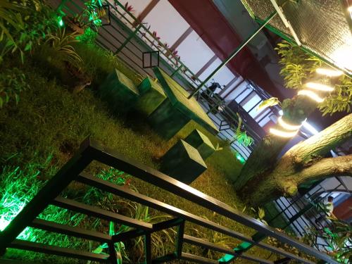 a set of stairs in a building with green lights at Seethevi Hotels in Batticaloa