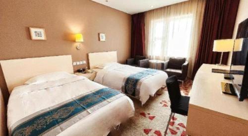 a hotel room with two beds and a chair at Super8 Hotel Anyang Hongqi Road in Anyang