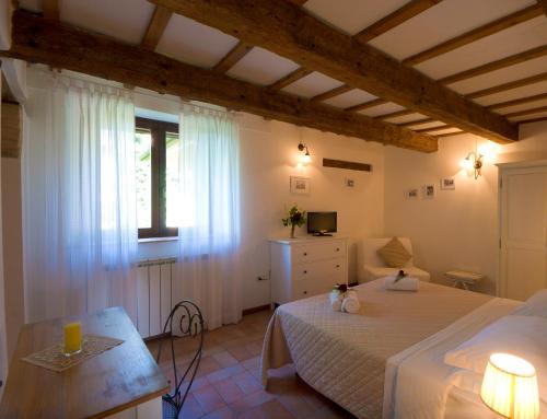 a bedroom with a bed and a table and a window at B&B Cristina in Porto Recanati