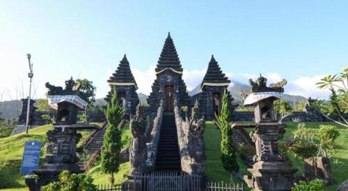 a building with several towers in a field at Herman Lantang Camp in Bogor