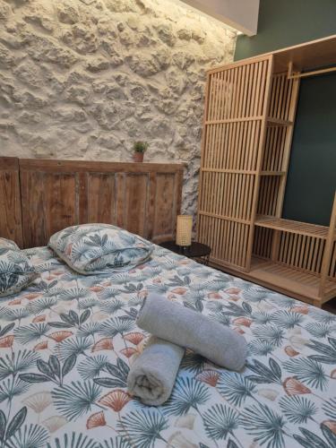 a bedroom with a bed with a towel on it at La Maison Or Azur- Spa Jacuzzi- Terrasse - Vue Nature in Penne-dʼAgenais