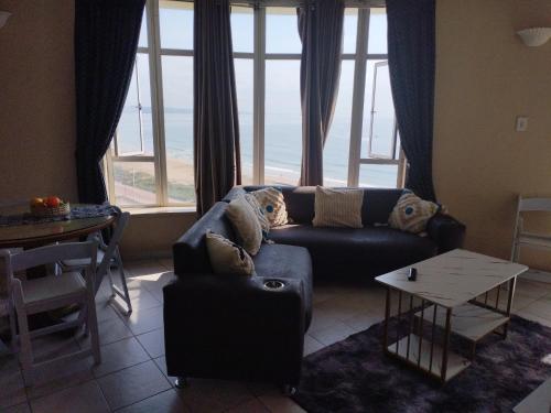 a living room with a couch and a table at Tenbery1002 in Durban