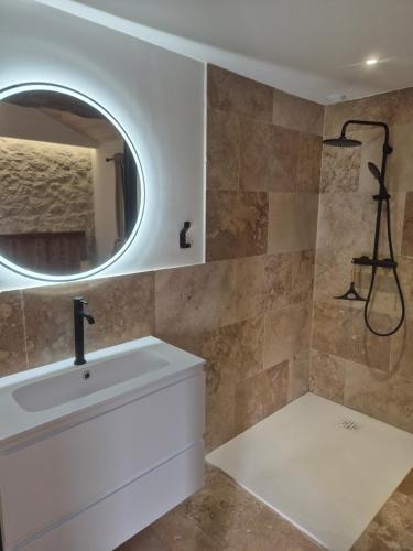 a bathroom with a sink and a mirror at La Maison Or Azur- Spa Jacuzzi- Terrasse - Vue Nature in Penne-dʼAgenais