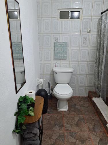 a bathroom with a toilet and a mirror at Departamento en San Quintín BC in San Quintín