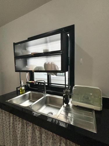 a kitchen sink with a window above it at D sleep Villa Chiangmai in Chiang Mai