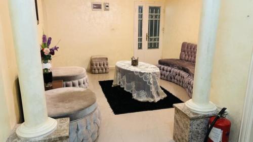a living room with a table and a couch at Petra center suite in Wadi Musa