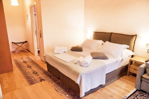 a bedroom with a large bed with towels on it at Elova in Zátouna