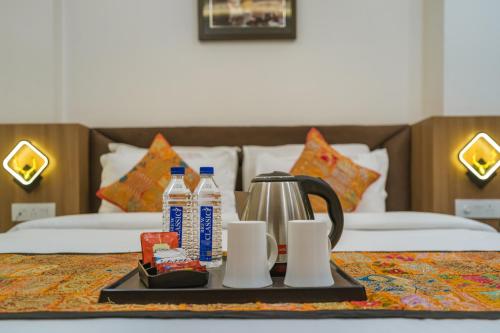 a tray with a coffee maker on a table in a hotel room at Tripli Hotels Sandalwood in Varanasi